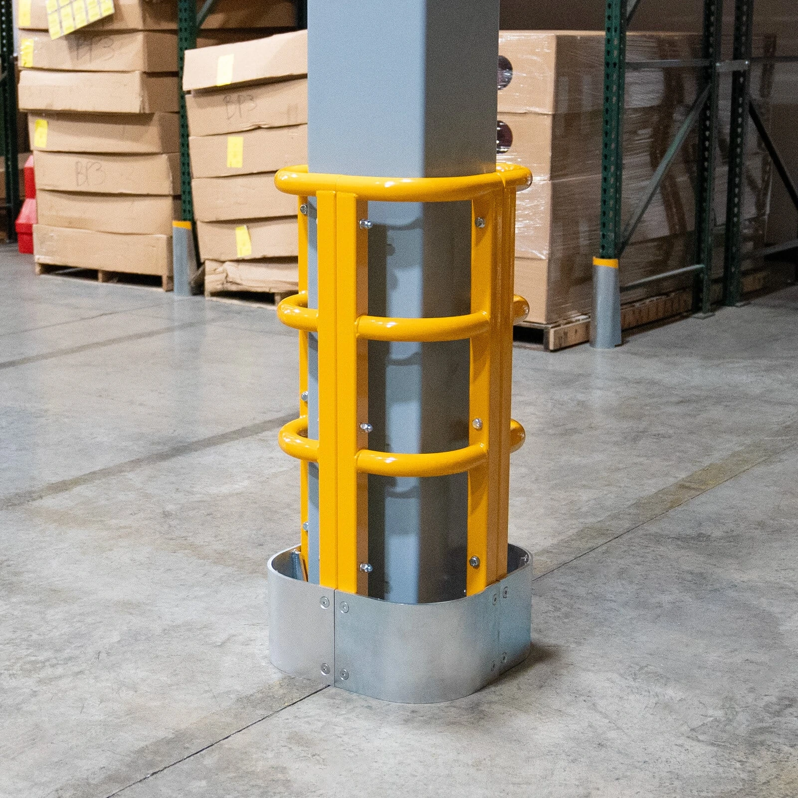 High-visibility warehouse column protector installed around an exposed column to reduce forklift impact damage.
